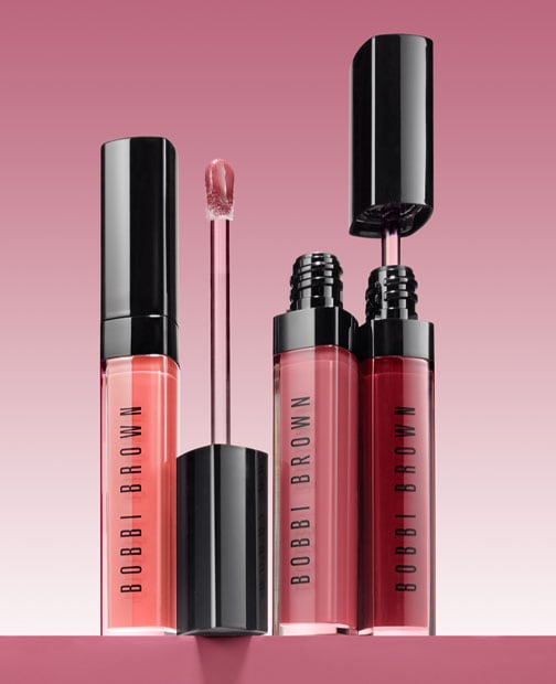Visual of close up lip gloss products with product wand open and closed
